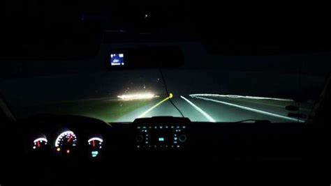 Timelapse of car driving at night. View from inside of a car with luminous dashboard and road ...