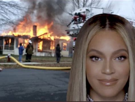 a woman with blonde hair standing in front of a house that has been on fire