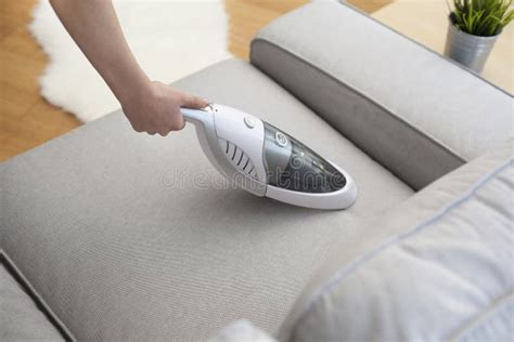 Woman with Handheld Vacuum Cleaning on Sofa Stock Photo - Image of ...