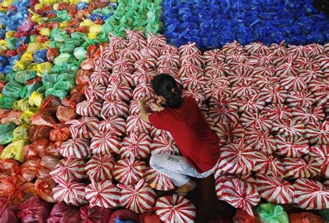 A student prepares disaster relief packages before distributing them ...