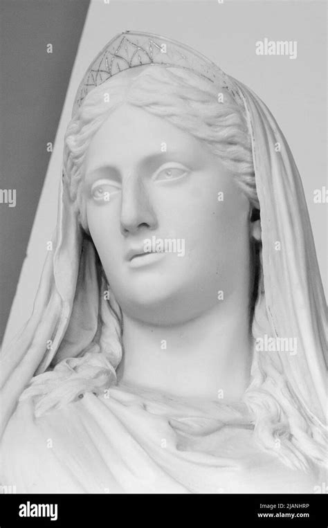White marble head of young woman. Statue of a woman in the antique style. Ancient sculpture of ...