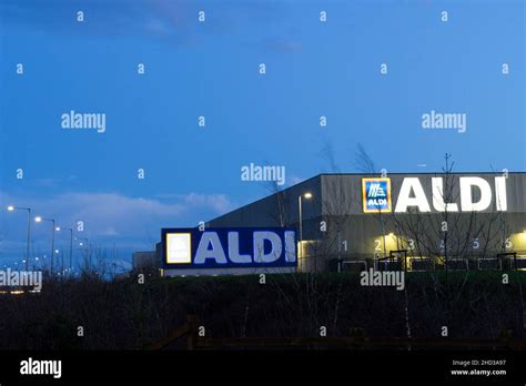 Store logo at night for ALDI supermarket England UK Stock Photo - Alamy