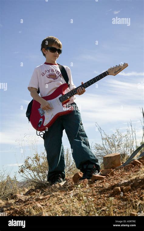 Young Boy Playing Electric Guitar Stock Photo - Alamy