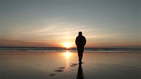 Man Walking Away On Sandy Beach To The Pacific Ocean In Oregon's ...