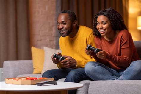 Premium Photo | Emotional african american man and woman enjoying video games