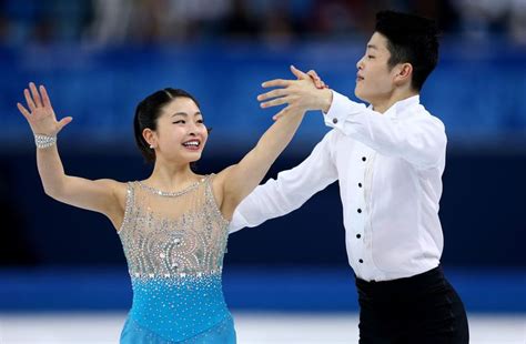 a man and woman are dancing on the ice