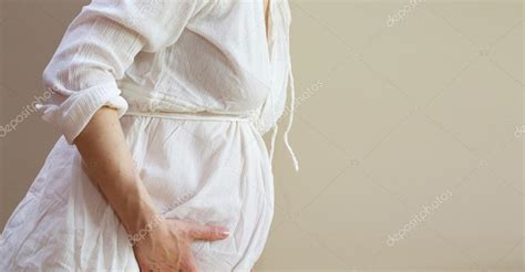 Delivery pain - contractions by a pregnant woman Stock Photo by ©Tolikoff 88167502