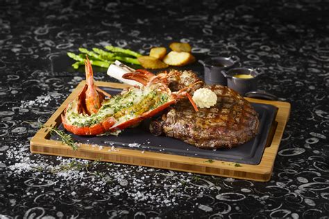 Chargrilled beef steaks with sumptuous live Canadian lobsters. # ...