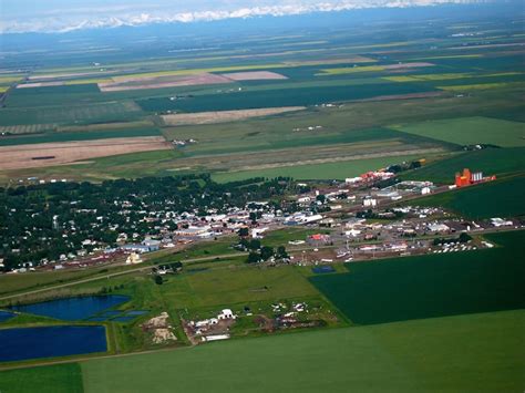 an aerial view of a small town surrounded by fields