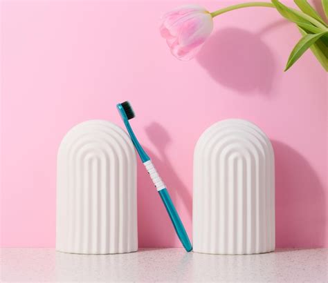 Premium Photo | Blue plastic toothbrush on pink background