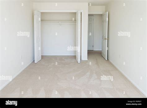 Small empty carpeted bedroom in a condominium unit - USA Stock Photo ...