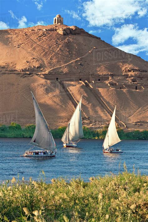 Egypt, Aswan, Nile River, Felucca sailboats, temple ruins and the large sand dunes of the Sahara ...