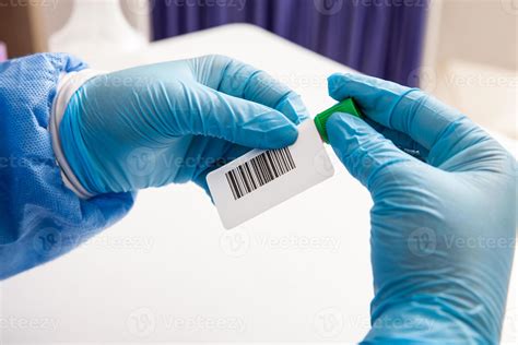 Closeup of a nurse labelling a test tube with blood sample in a ...