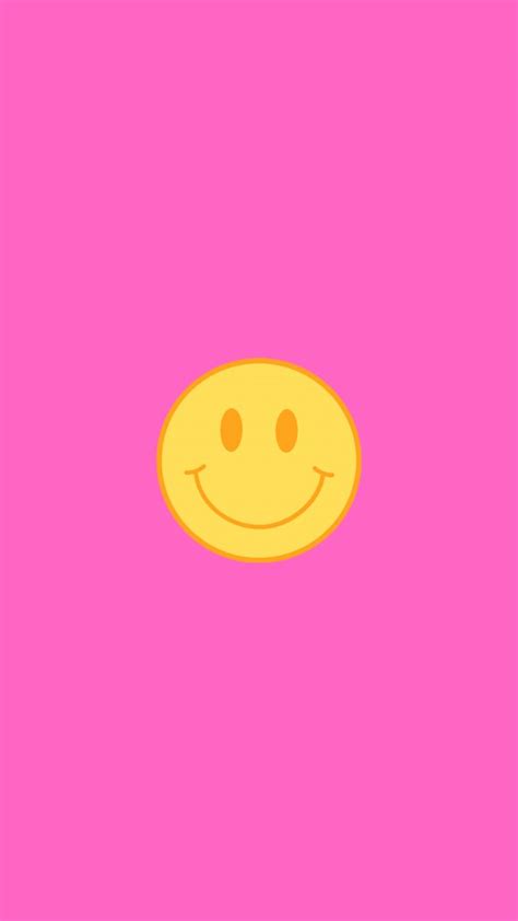 a yellow smiley face on a pink background