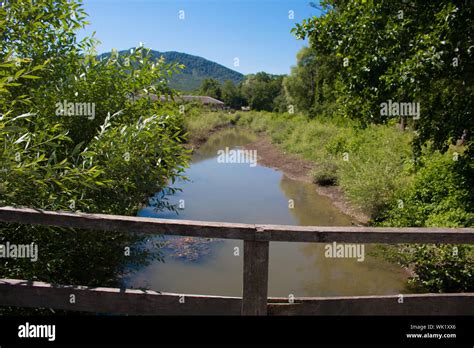 Wooden bridge over the river Stock Photo - Alamy