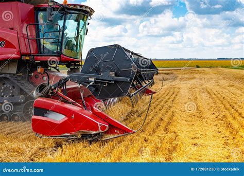 A Red Combine Harvester with a Mower in a Field Stock Photo - Image of ...