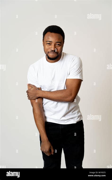 Half length portrait of attractive shy young african american man with ...