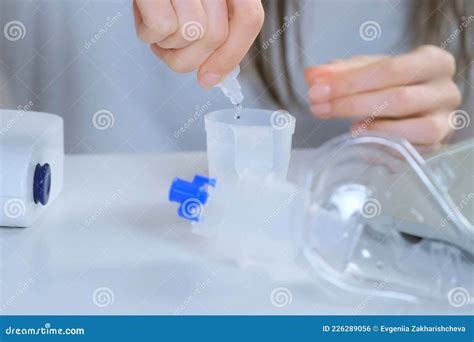 Woman is Preparing Nebulizer for Inhalation at Home on Table, Closeup ...