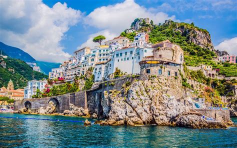 The small haven of Amalfi village with the tiny beach and colorful houses, located on the rock ...