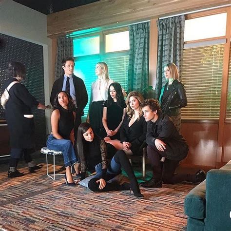 a group of people standing and sitting in a living room