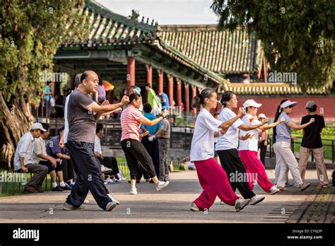 Chinese people practice tai chi martial arts exercise early morning at the Temple of Heaven Park ...