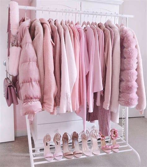 a rack filled with lots of pink clothes