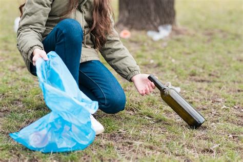 Free Photo | Girl cleaning a glass bottle from ground