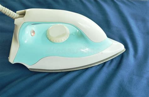 Blue Automatic Electric Iron Pressing Cloth on Ironing Board Stock ...