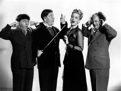 A vintage press shot of comic legends' The Three Stooges with co-star Christine McIntyre for the ...