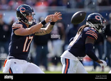 Chicago Bears quarterback Tyson Bagent takes the snap from center in the shotgun formation ...