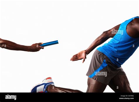 Athlete passing relay baton Stock Photo - Alamy