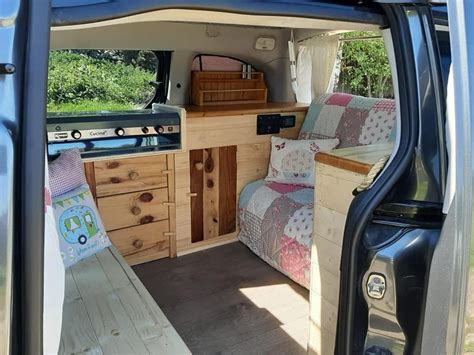 the interior of an rv with wood furniture and storage compartments on the door, inside view