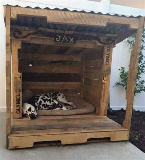 Rustic doghouse made from pallets with covered front porch, big opening, and corrugated roof ...