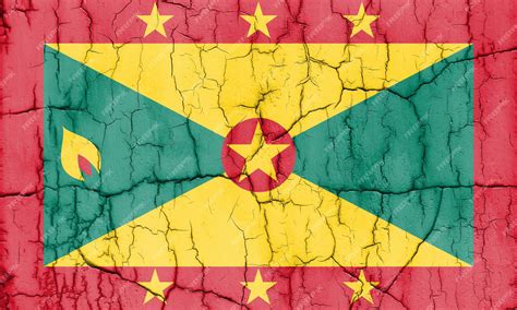 Premium Photo | Flag of grenada on cracked wall textured background