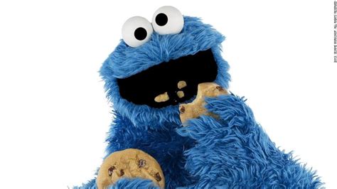 Cookie Monster eating one Cookie while holding another Cookie in ...