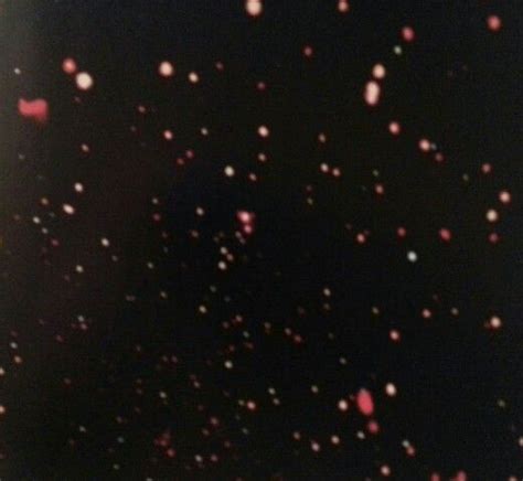 the sky is filled with pink and white dots on black paper, as well as ...