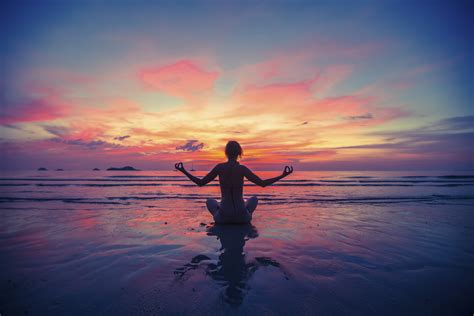 Woman doing meditation near the ocean beach. Yoga silhouette. * Alisoun Mackenzie