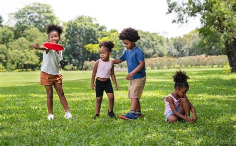 Premium Photo | African American kids play frisbee in the park