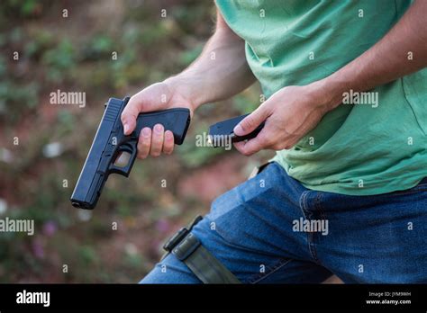 Guy with the pistol gun glock desert eagle changing bullets in the ...