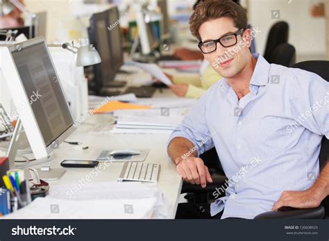 Man Working At Desk In Busy Creative Office Stock Photo 130608929 : Shutterstock