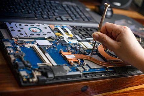 Hand Dismantle the Laptop. Laptop Repair with a Screwdriver Stock Image ...