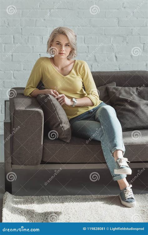 Beautiful Girl Sitting on Sofa and Looking Stock Image - Image of room, caucasian: 119828081