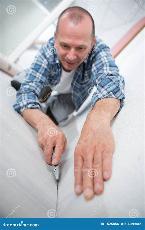 Male Carpet Fitter Installing Carpet with Cutter Stock Photo - Image of renovation, handyman ...