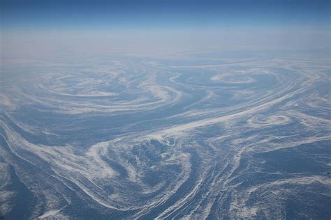 the view from an airplane looking down at swirly lines in the sky