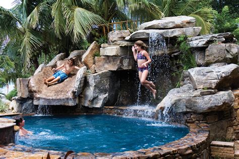 Custom Swimming Pool with Natural Stone Waterfalls and Pool Grotto ...