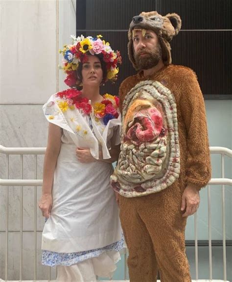 a man and woman dressed in costumes standing next to each other