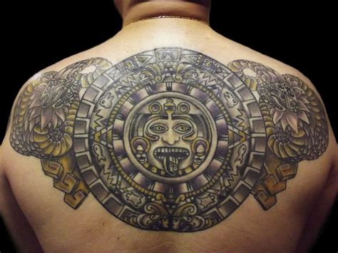 A tattoo of the Mayan calendar surrounded by mayan serpent tattoos ...