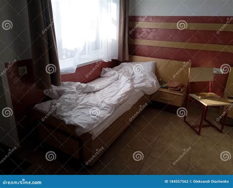 Cheap hotel room with bed stock photo. Image of damaged - 184557562