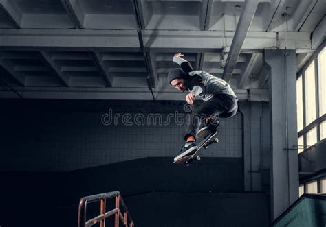 Young Skateboarder Performing a Trick on Mini Ramp at Skate Park Indoor ...