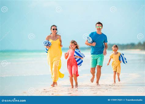 Happy Beautiful Family of Four on the Beach Stock Image - Image of maldives, coastline: 170917031